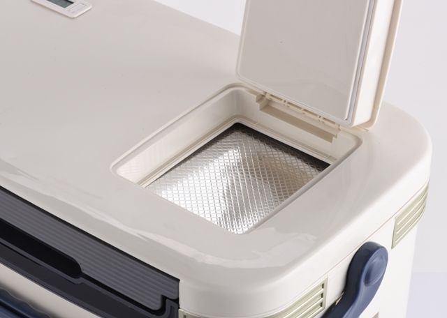 A beige Nomad Medical Cooler 28L with a black carrying handle and alarmed thermometer display on the top. The brand logo is printed on the front.