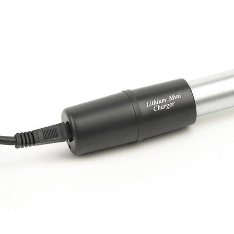 A black lithium mini charger with a connected power cord, designed to provide a fast charge to compatible medical device handles.