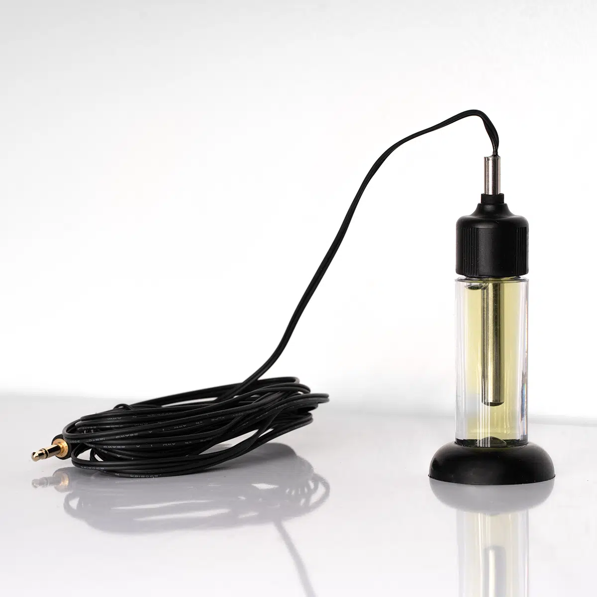 A WiFi datalogger with an external thermistor probe, placed next to a black cable, designed to mimic a vaccine temperature monitoring scenario.