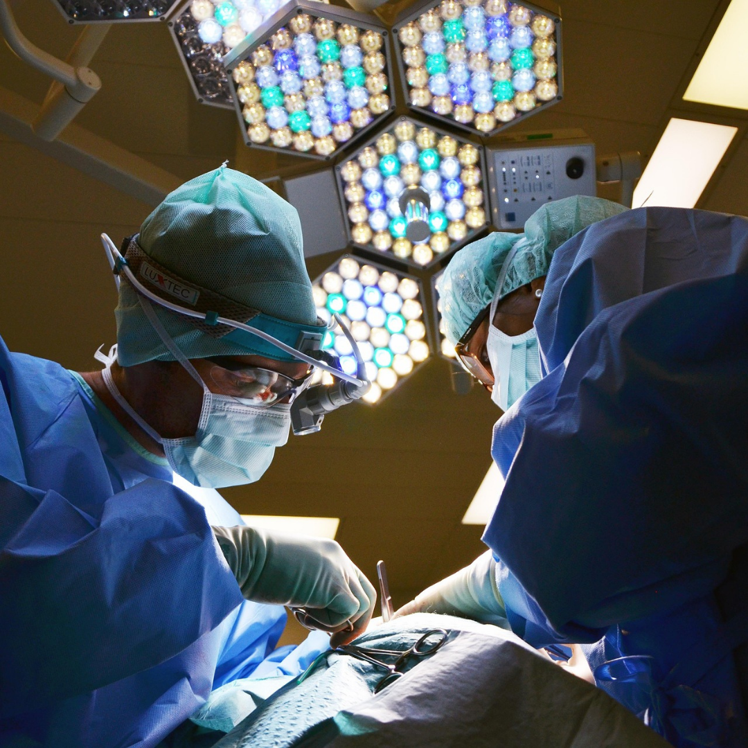 Surgeons performing surgery in an operating room with medical surgery lights