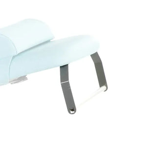 A metal paper roll holder with a blue cushion attached to it, designed to be fitted to a treatment couch.