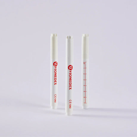 Three surgical skin marker pens with measuring scales printed on them, two with red markings and one with blue.